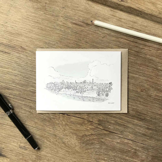 The view from Primrose Hill sketched on a greeting card with an envelope and pencil on a wooden surface