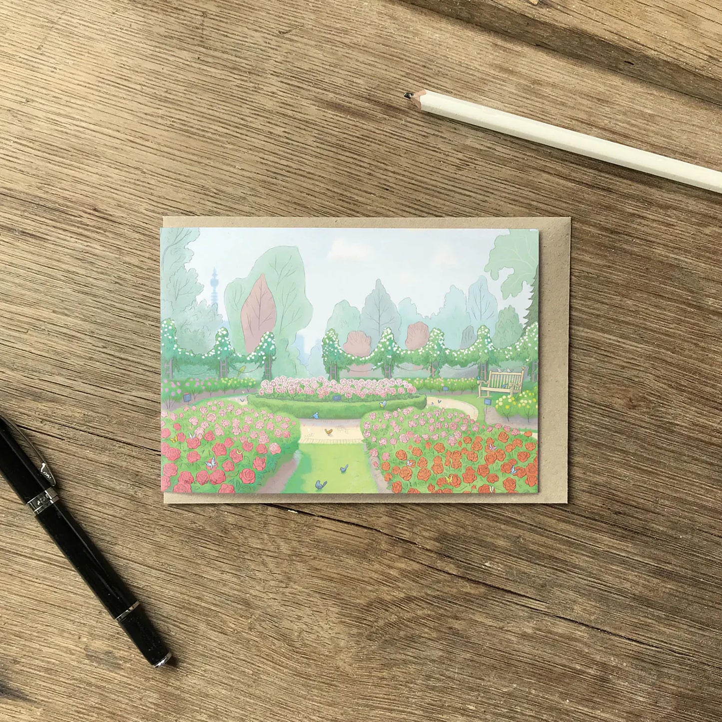 London's Queen Mary's Rose Garden painting from Regents Park on a greetings card on a wooden surface