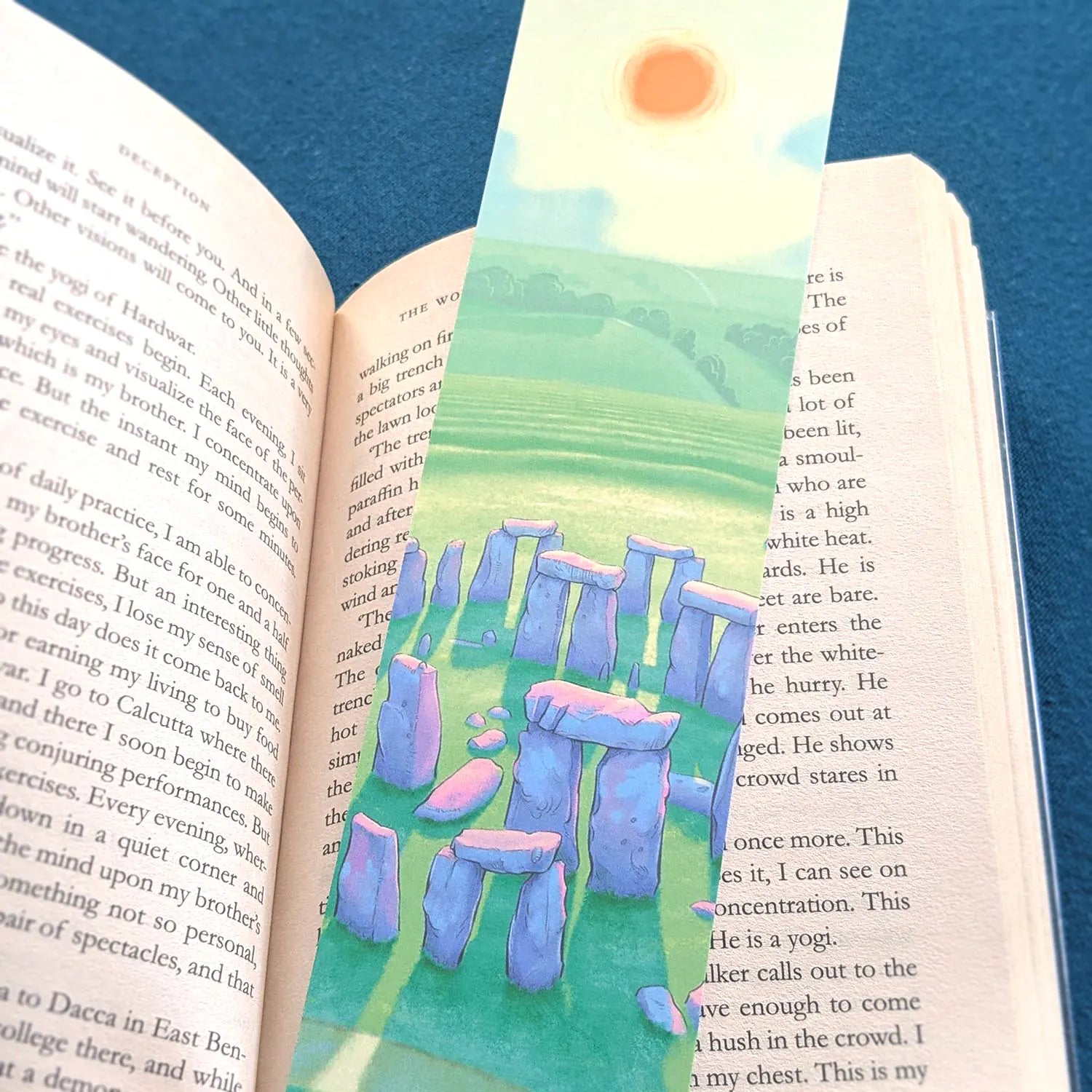 Bookmark with a painting of Stonehenge in Wiltshire England resting on a book