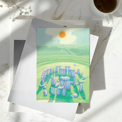 Greetings card with a painting of Stonehenge in Wiltshire England on a pile of books