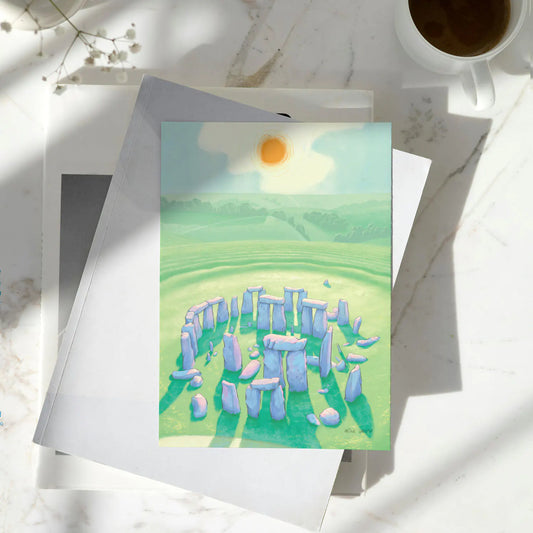 Greetings card with a painting of Stonehenge in Wiltshire England on a pile of books
