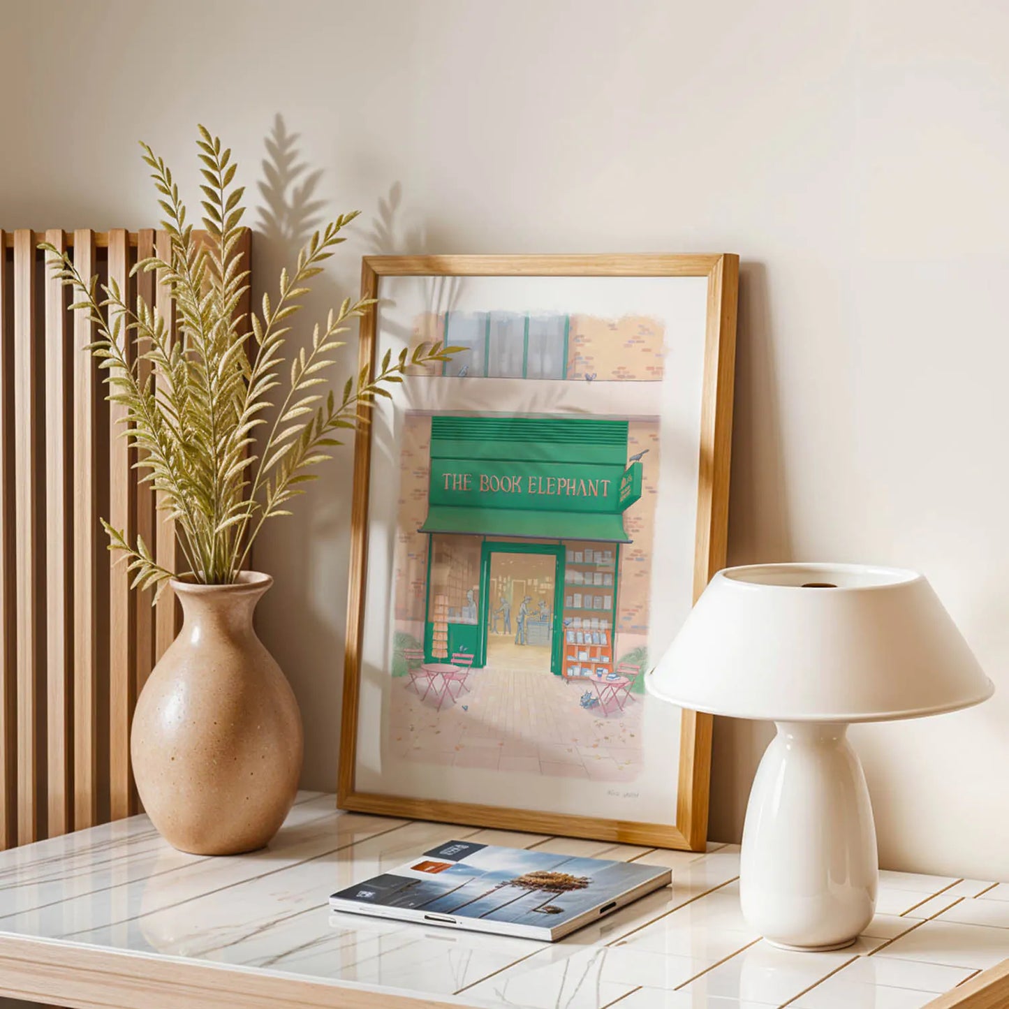 Framed wall art print of The Book Elephant shop in London with a lamp