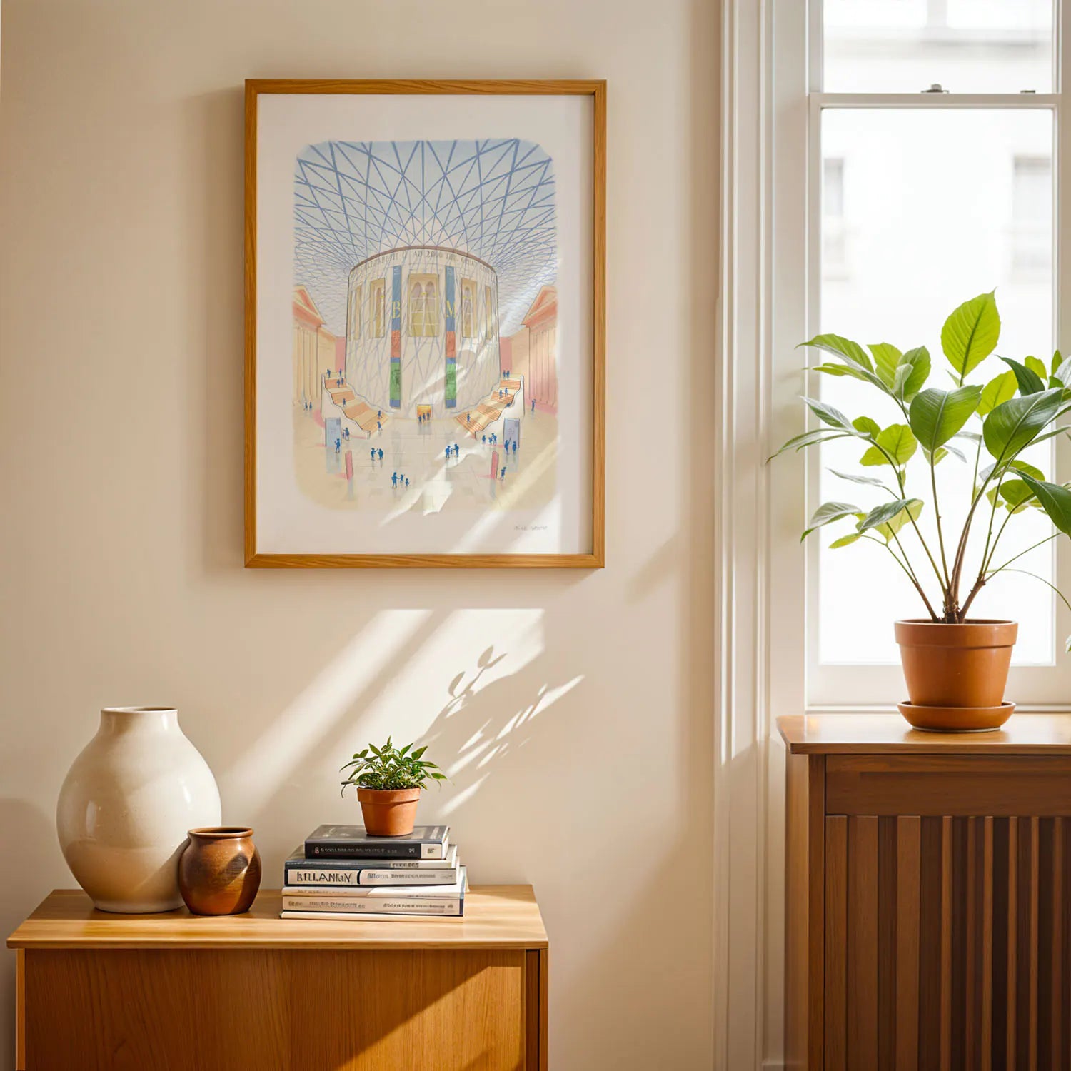 Wall art print of the British Museum great court in London next to a window with a plant