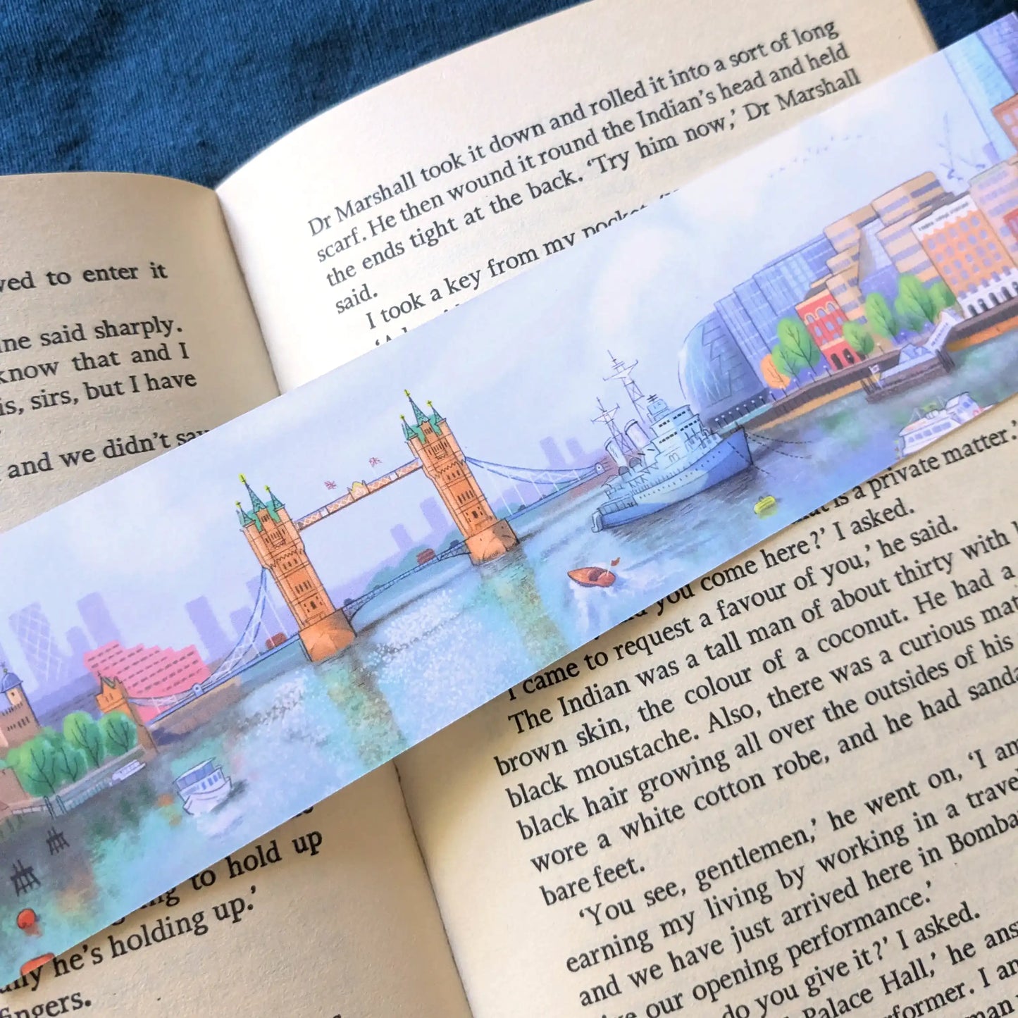 Tower bridge on the river Thames in London illustrated on a bookmark resting on an open book