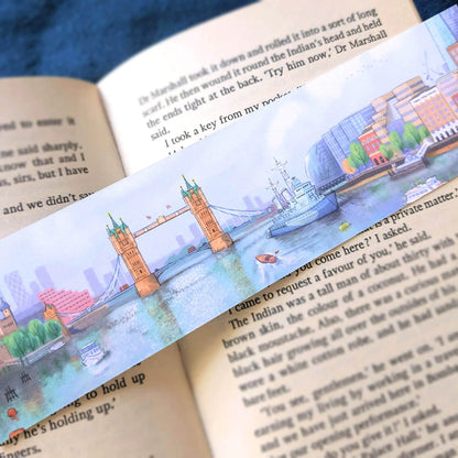 Tower bridge on the river Thames in London illustrated on a bookmark resting on an open book