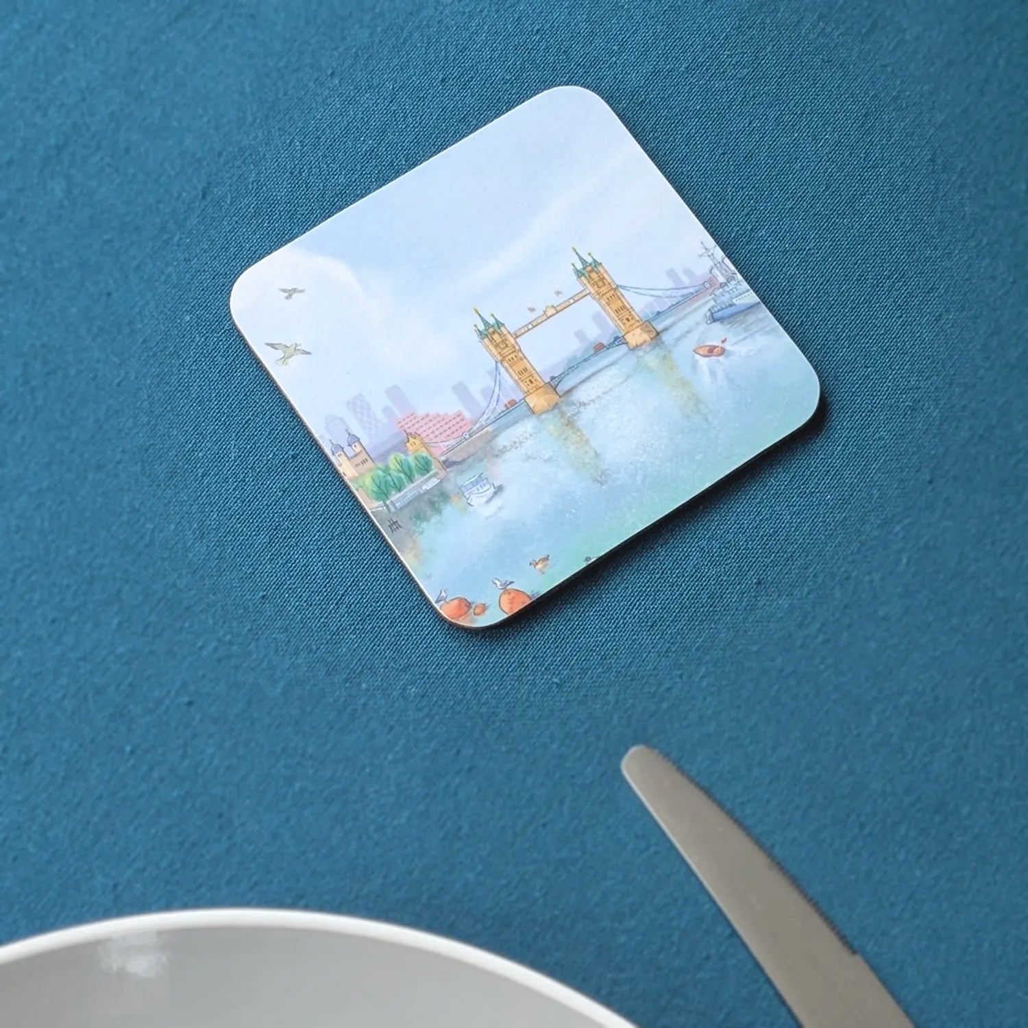 Coaster with a painting of Tower Bridge in London on the river Thames on a table cloth