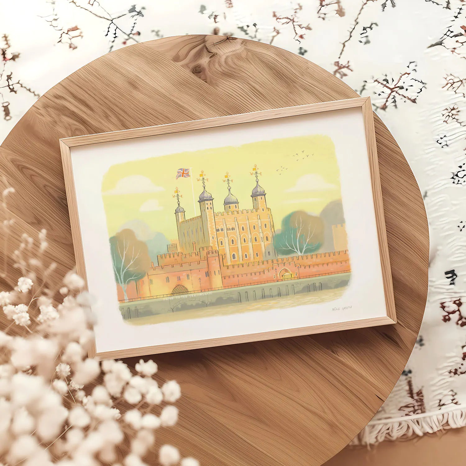 A framed art print of the Tower of London landmark on a round table