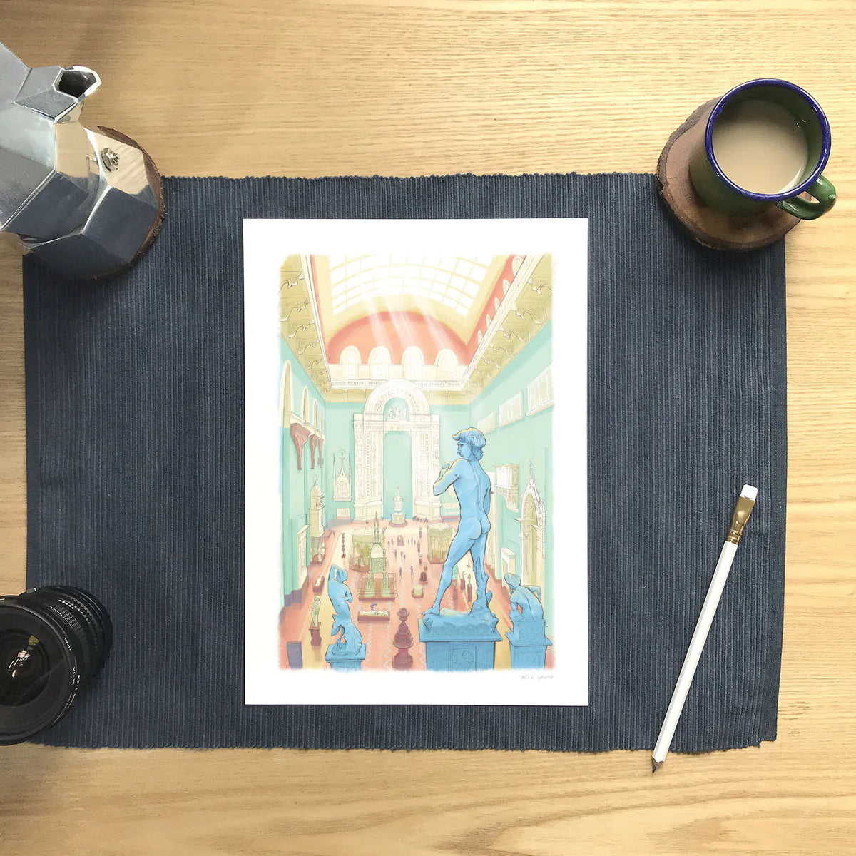 Wall art print of a painting of the Weston Cast Court in the Victoria and Albert Museum in London's South Kensington on a matt with a pencil and cup of coffee