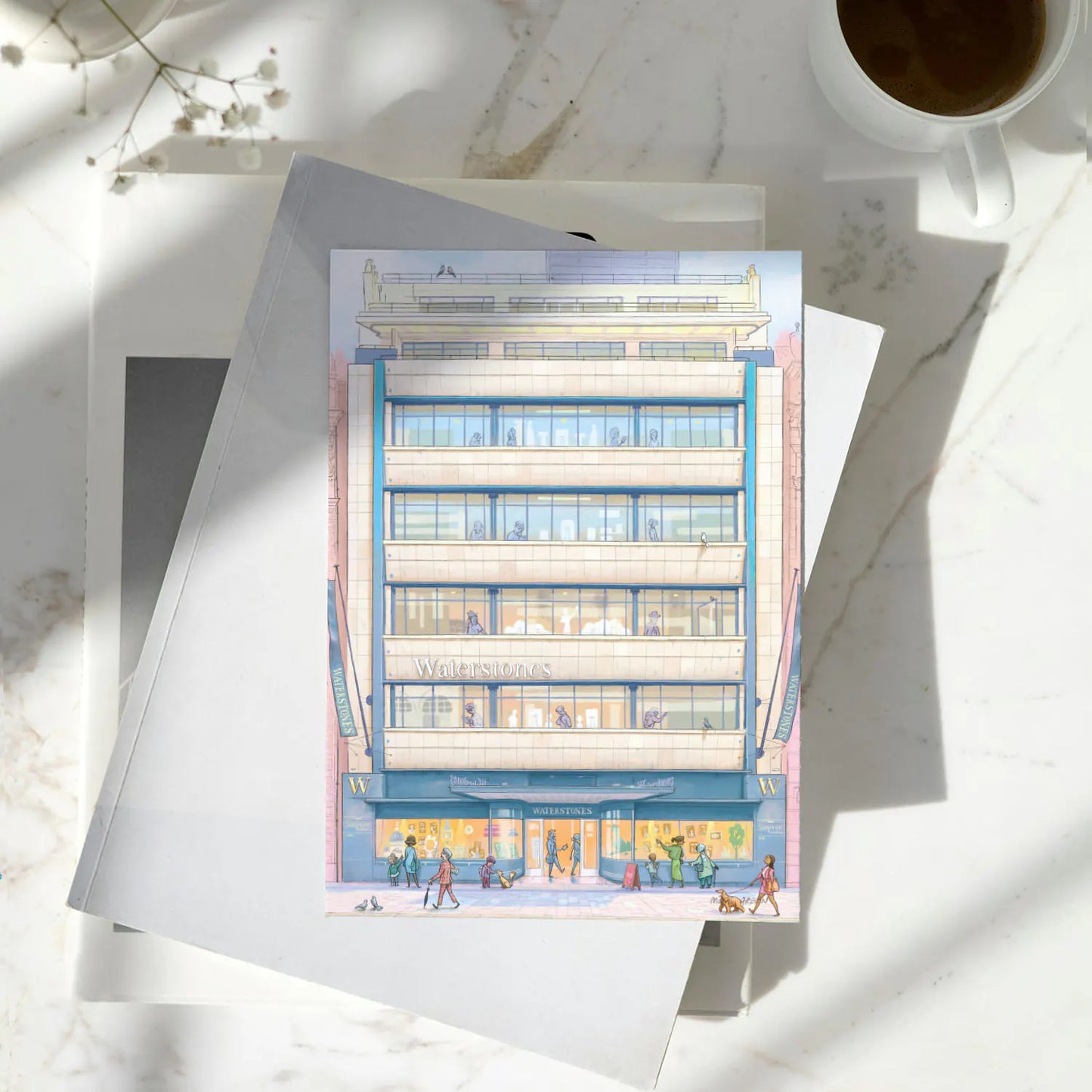 Greetings card of Waterstones Piccadilly bookstore in London on a pile of books with a coffee cup on a marble table