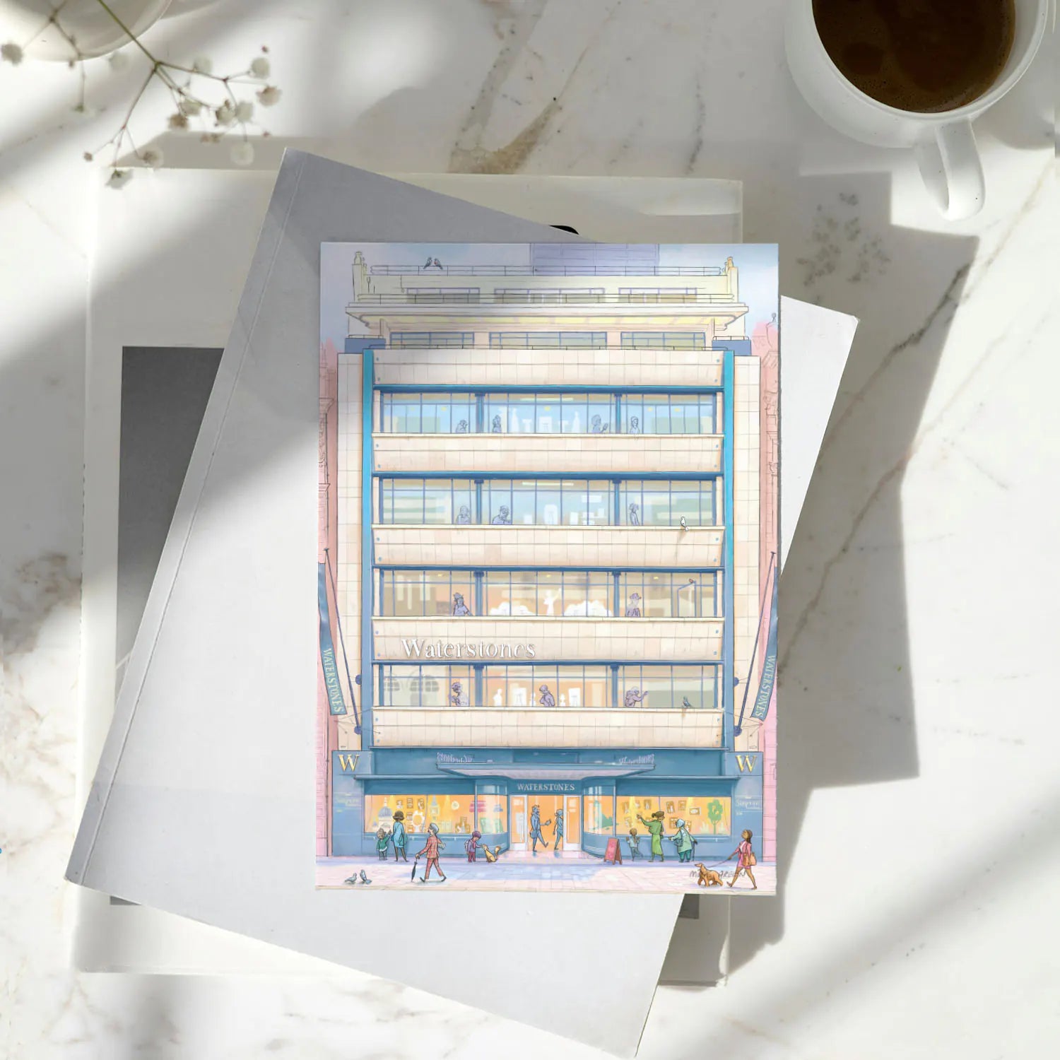 Greetings card of Waterstones Piccadilly bookstore in London on a pile of books with a coffee cup on a marble table