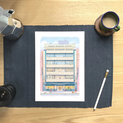 Wall art print of Waterstones Piccadilly bookstore on a mat with a coffee and pencil