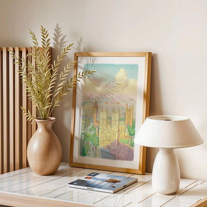 A wall art print of Westminster Abbey in a watercolour illustration style with big ben and the London Eye also shown framed in a room with a window and plants