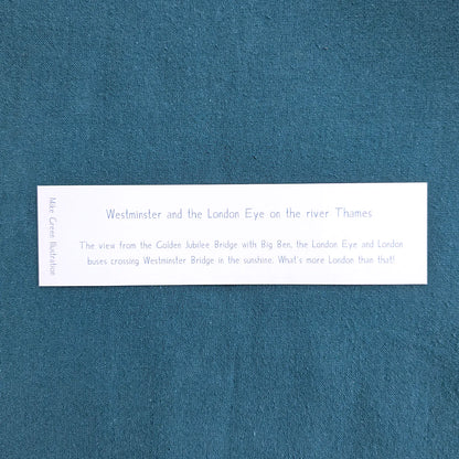 Back of a bookmark of Westminster's Big Ben and the London Eye on the Thames in London