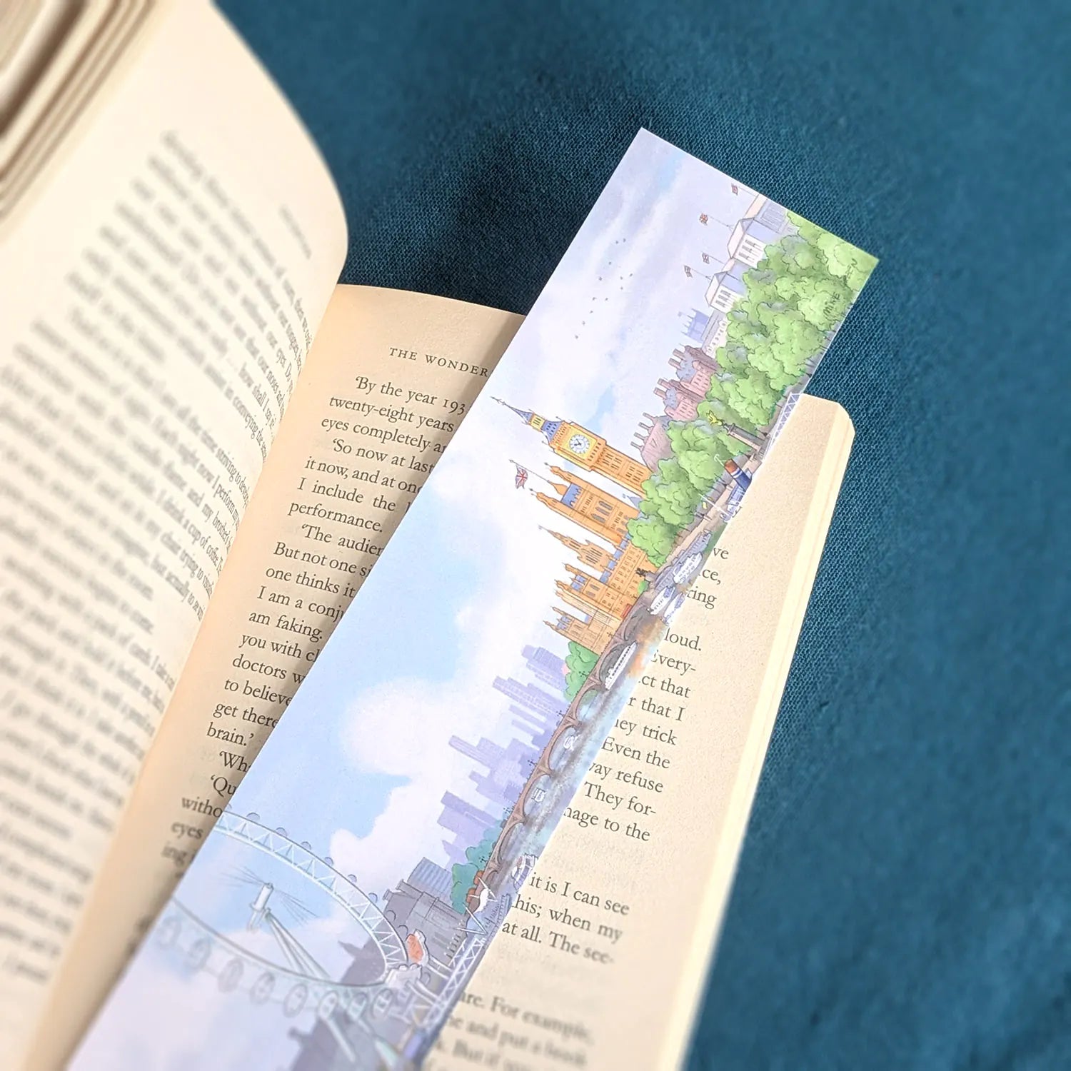 Bookmark with a painting of Big Ben and the London Eye resting on a book